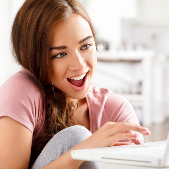 An adult woman laughing at her laptop, an illustrative stock-style portrait